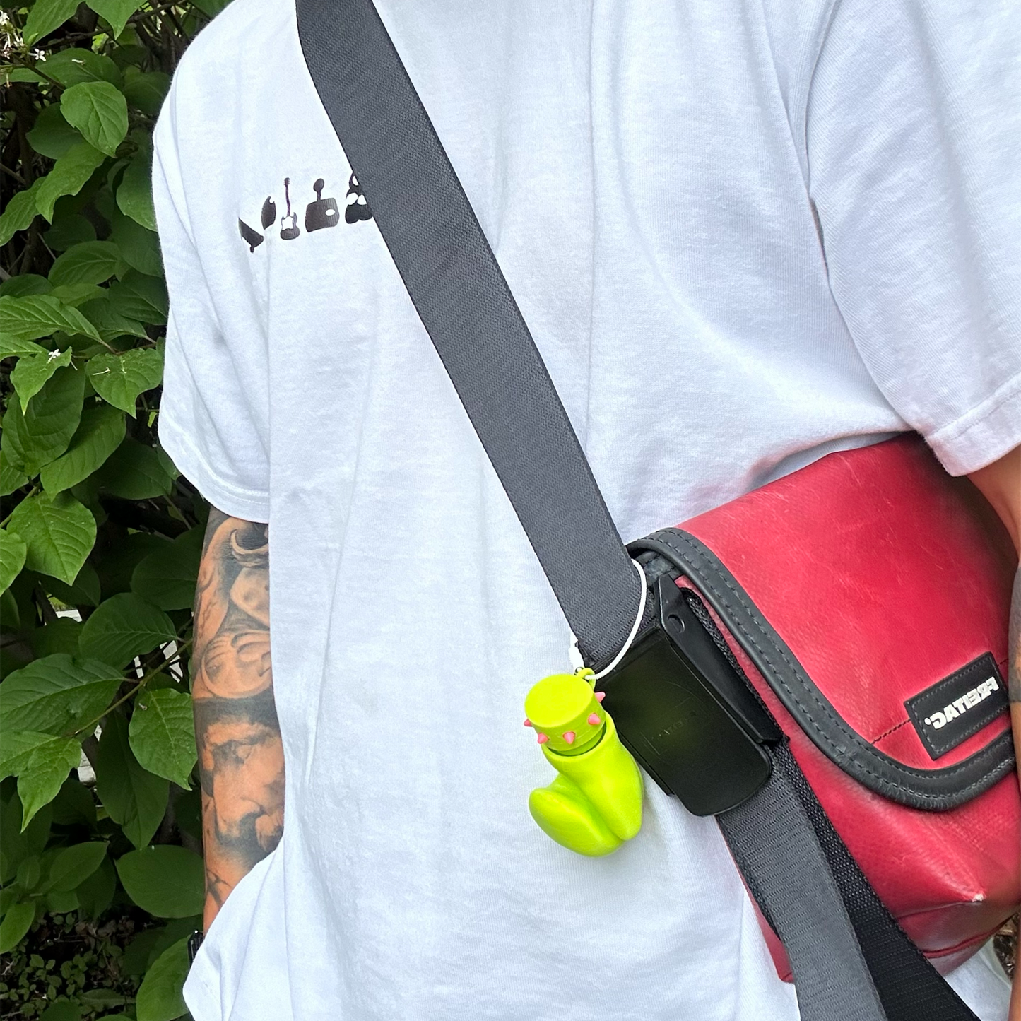 Neon Jab glove charm attached to a shoulder bag strap as a bagcharm accessory