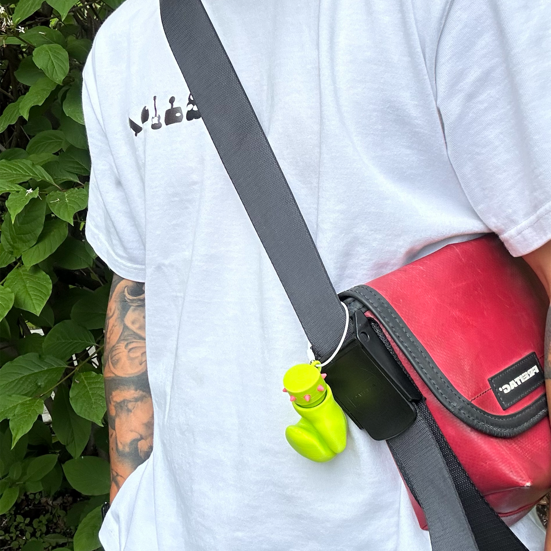 Neon Jab glove charm attached to a shoulder bag strap as a bagcharm accessory